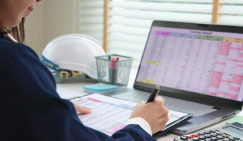 Person doing accounting on a laptop.
