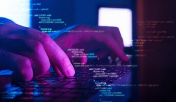 Person coding on laptop