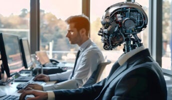 Robot employee sat next to human employee