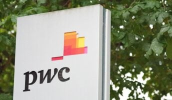 PwC logo on building side with trees