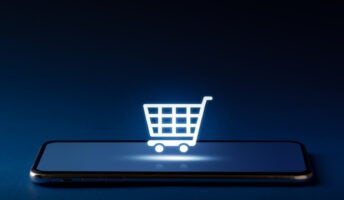 Shopping cart icon on top of mobile phone